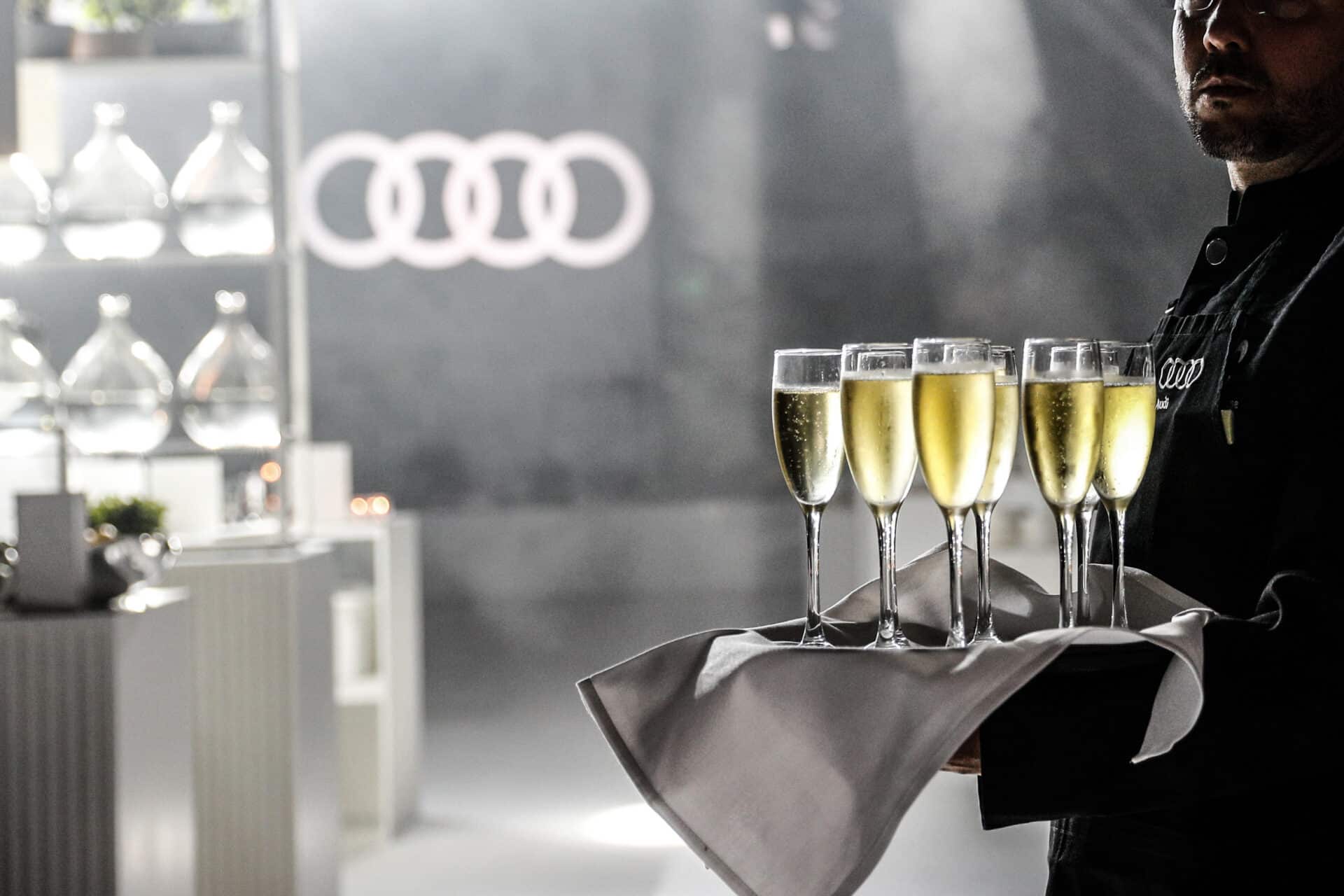 “Guests enjoying Audi Dealer of the Year lounge experience with premium design details”